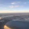 an airplane wing and wing of a city