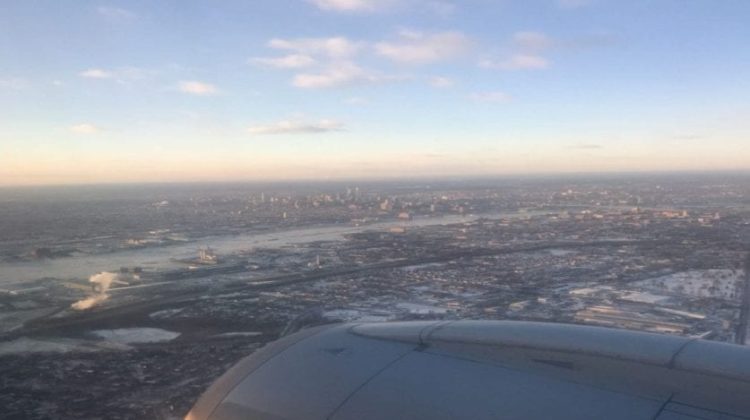 an airplane wing and wing of a city