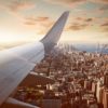 an airplane wing above a city