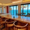 a bar with chairs and a chandelier