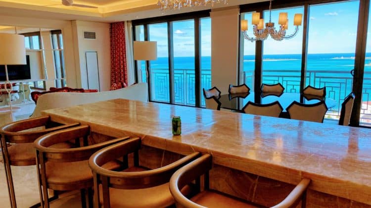 a bar with chairs and a chandelier