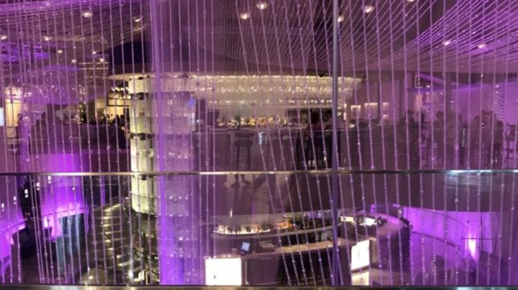 a glass wall with purple lights