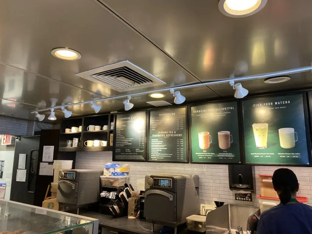 a coffee shop with a menu board