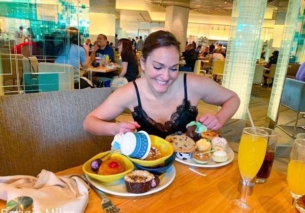 a woman sitting at a table with food on it