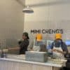 a group of people in hard hats behind a counter