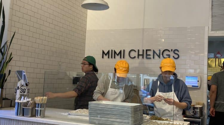 a group of people in hard hats behind a counter