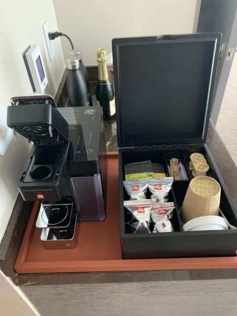 a coffee machine and coffee condiments on a table