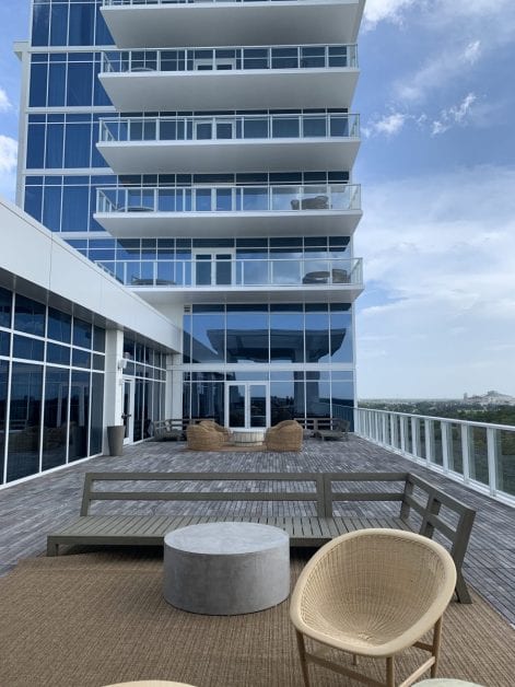 a building with a balcony and chairs