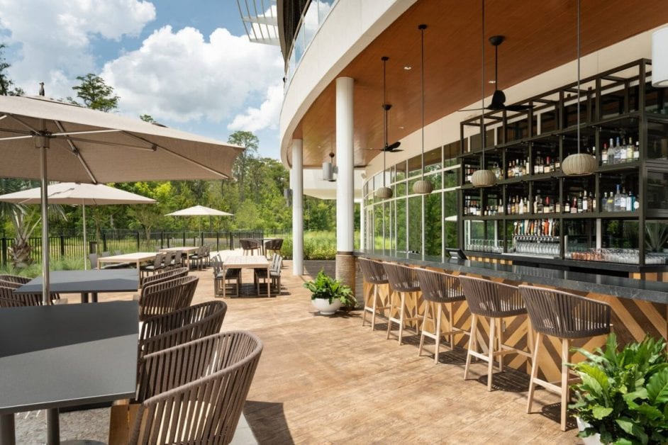 a patio with a bar and chairs