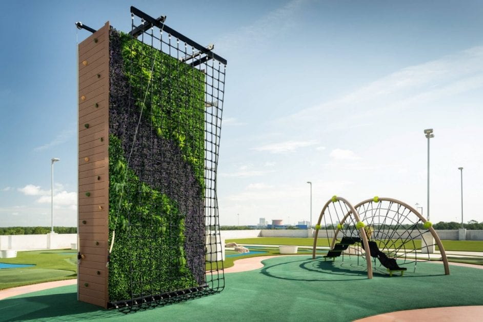 a playground with climbing wall and climbing equipment