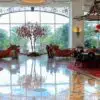 a large room with a tree and red lanterns