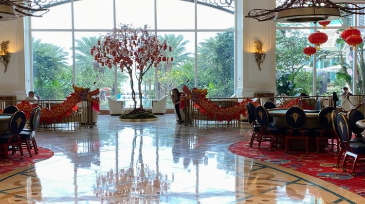 a large room with a tree and red lanterns