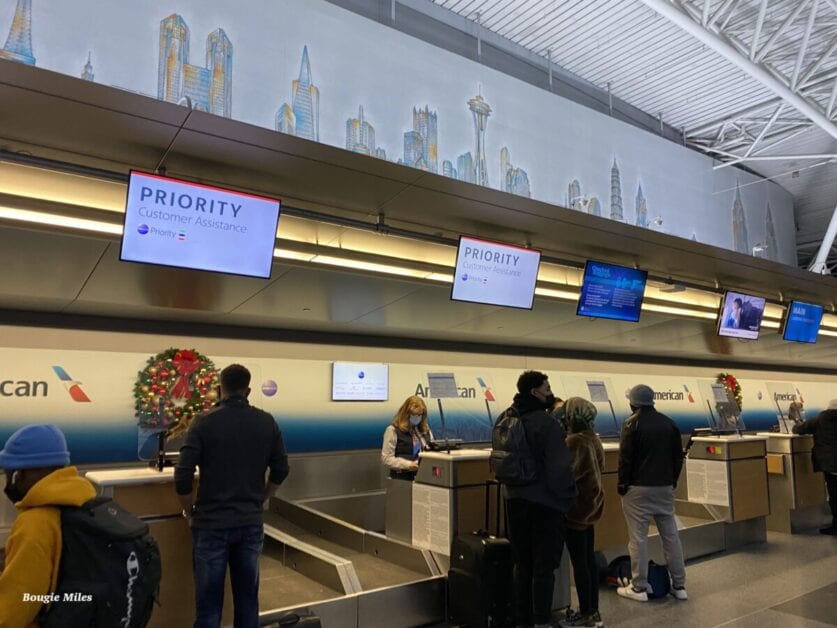 people standing in front of a check-in counter