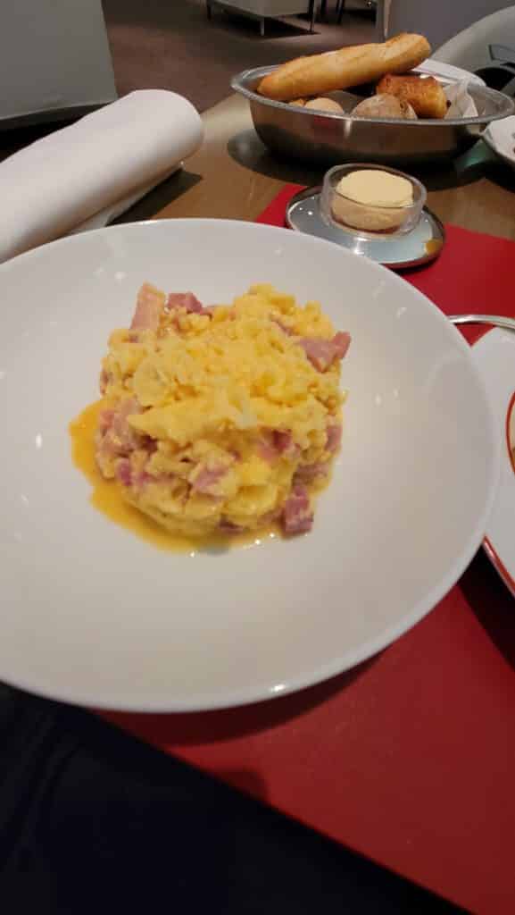 a plate of scrambled eggs and ham