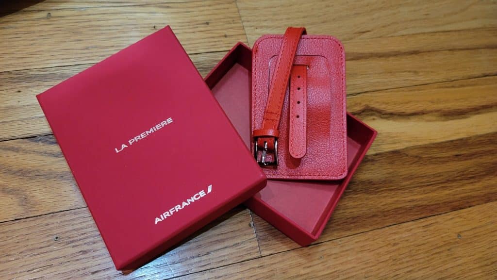 a red case and luggage tag in a box