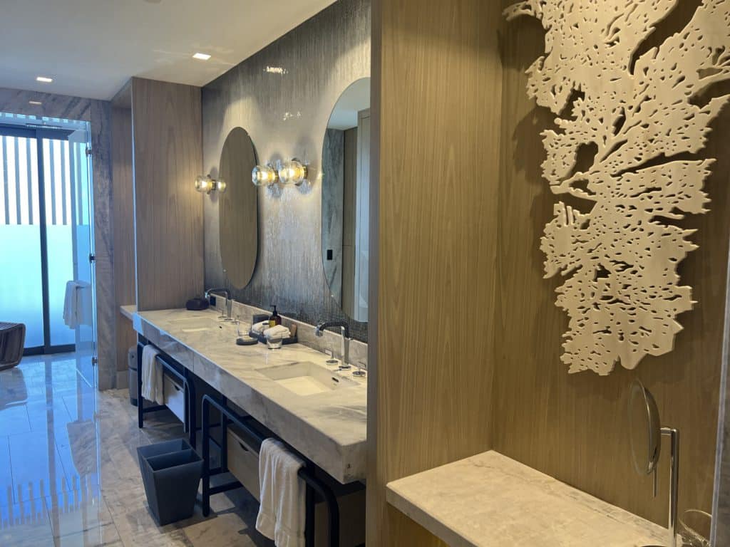 a bathroom with marble counter tops and mirrors