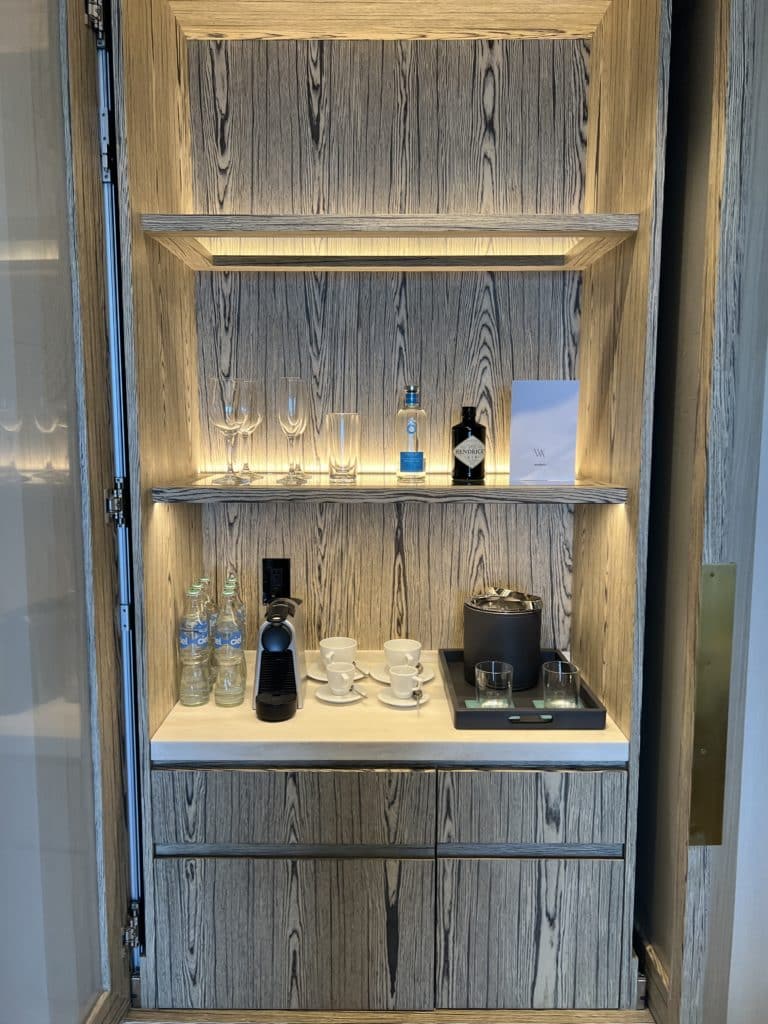 a shelf with drinks and glasses on it