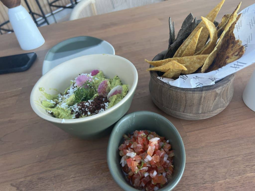 a bowl of guacamole and chips on a table