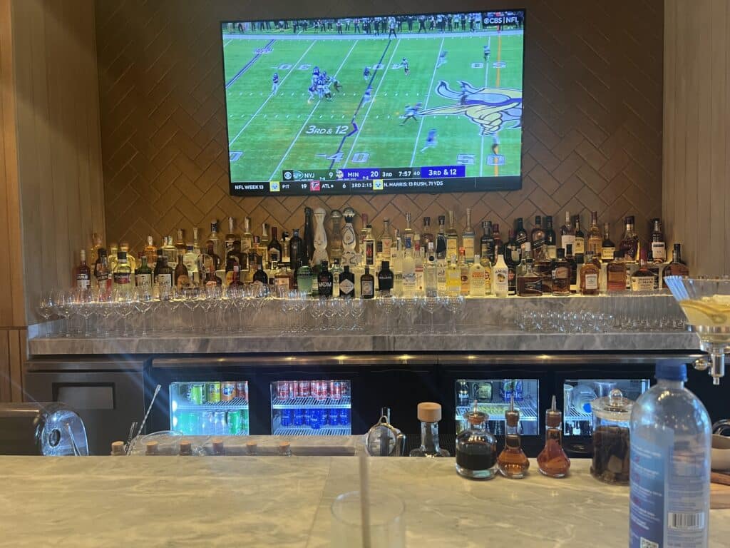 a bar with a television and bottles of liquor