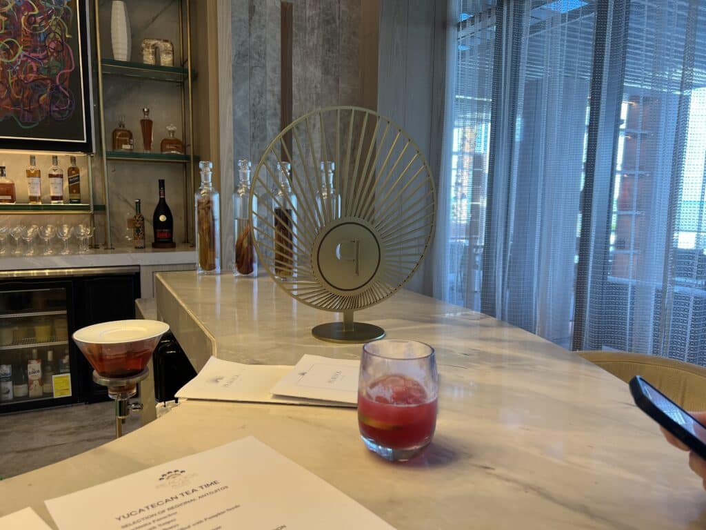 a table with a fan and drinks on it