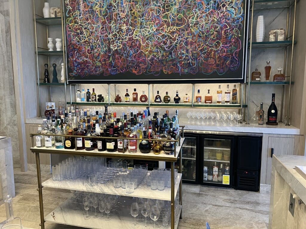 a bar with many bottles and glasses