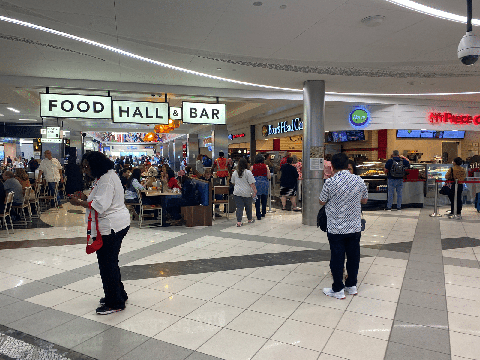 people in a mall with people eating food