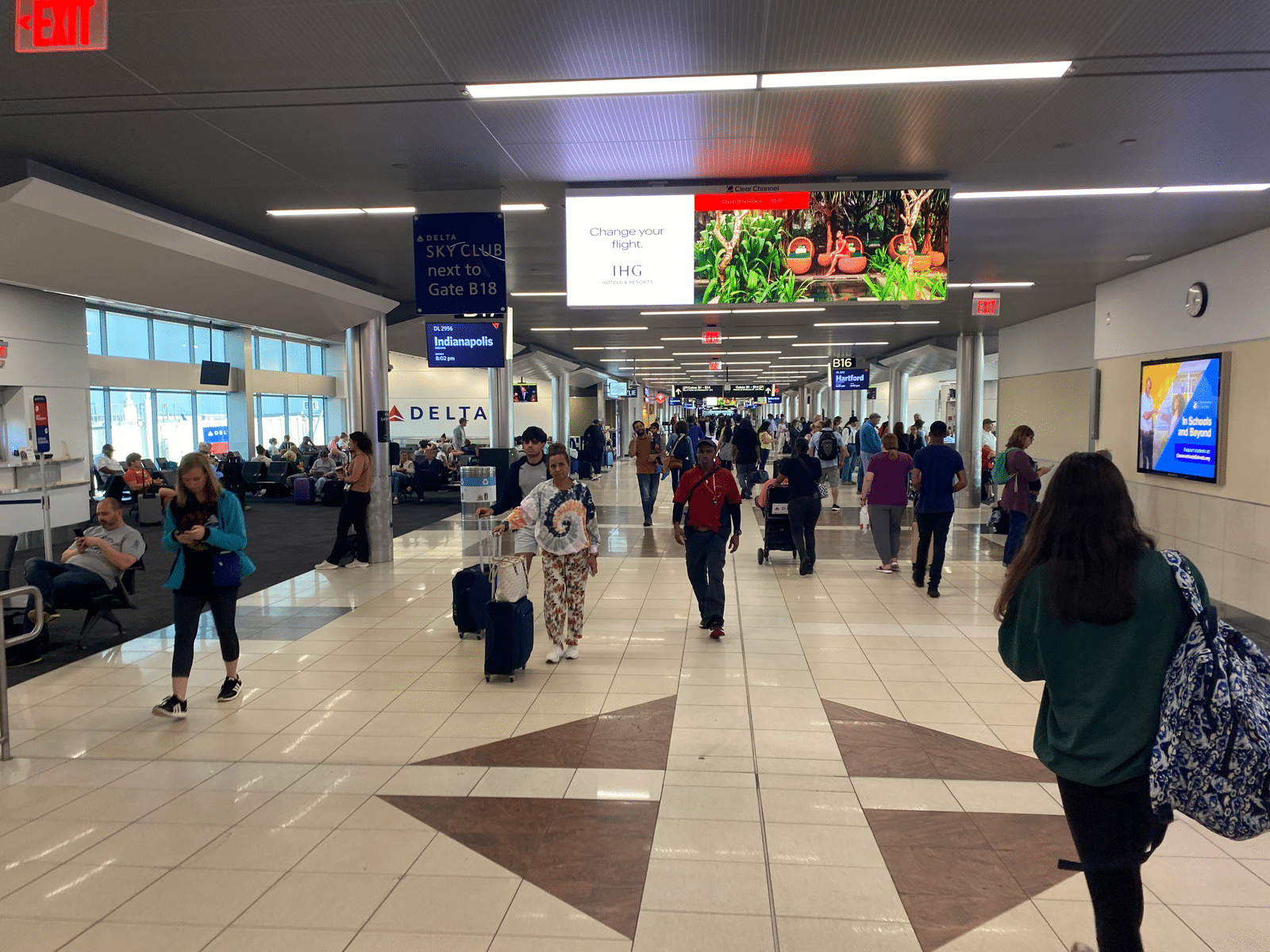 a group of people walking in an airport