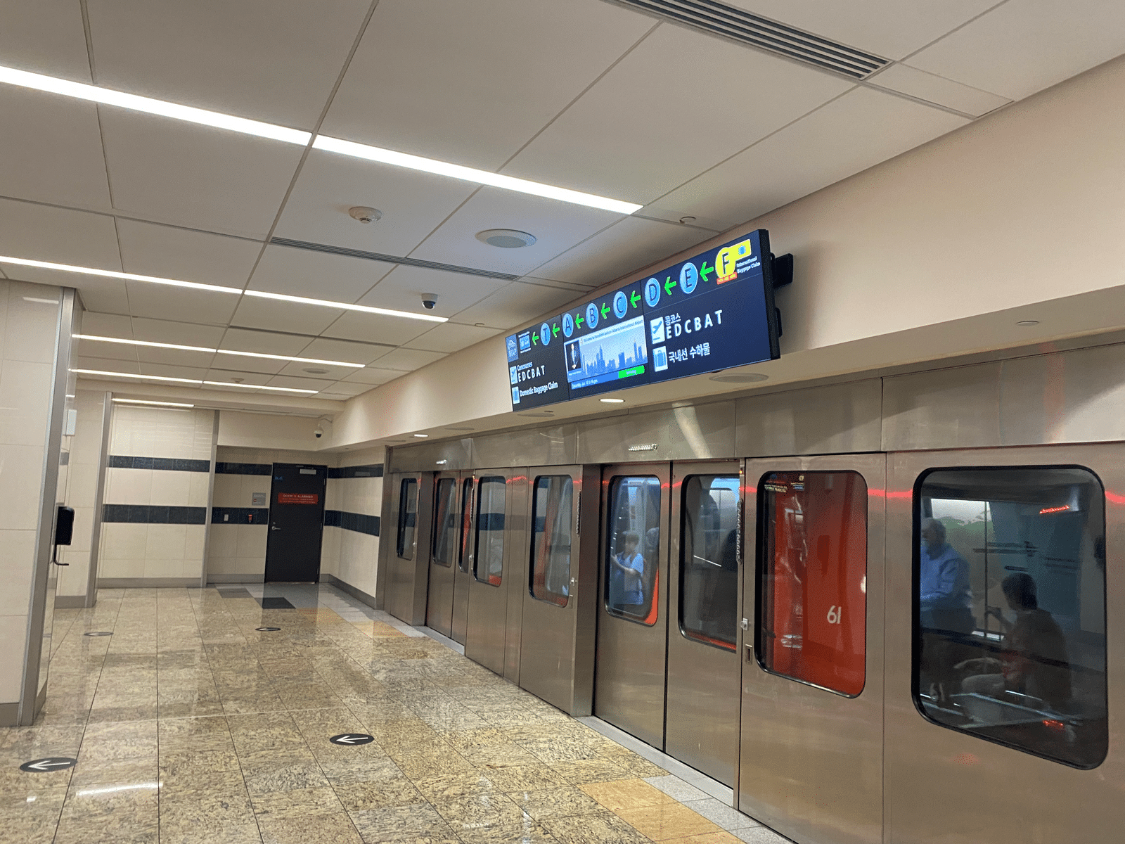a subway station with doors and a sign