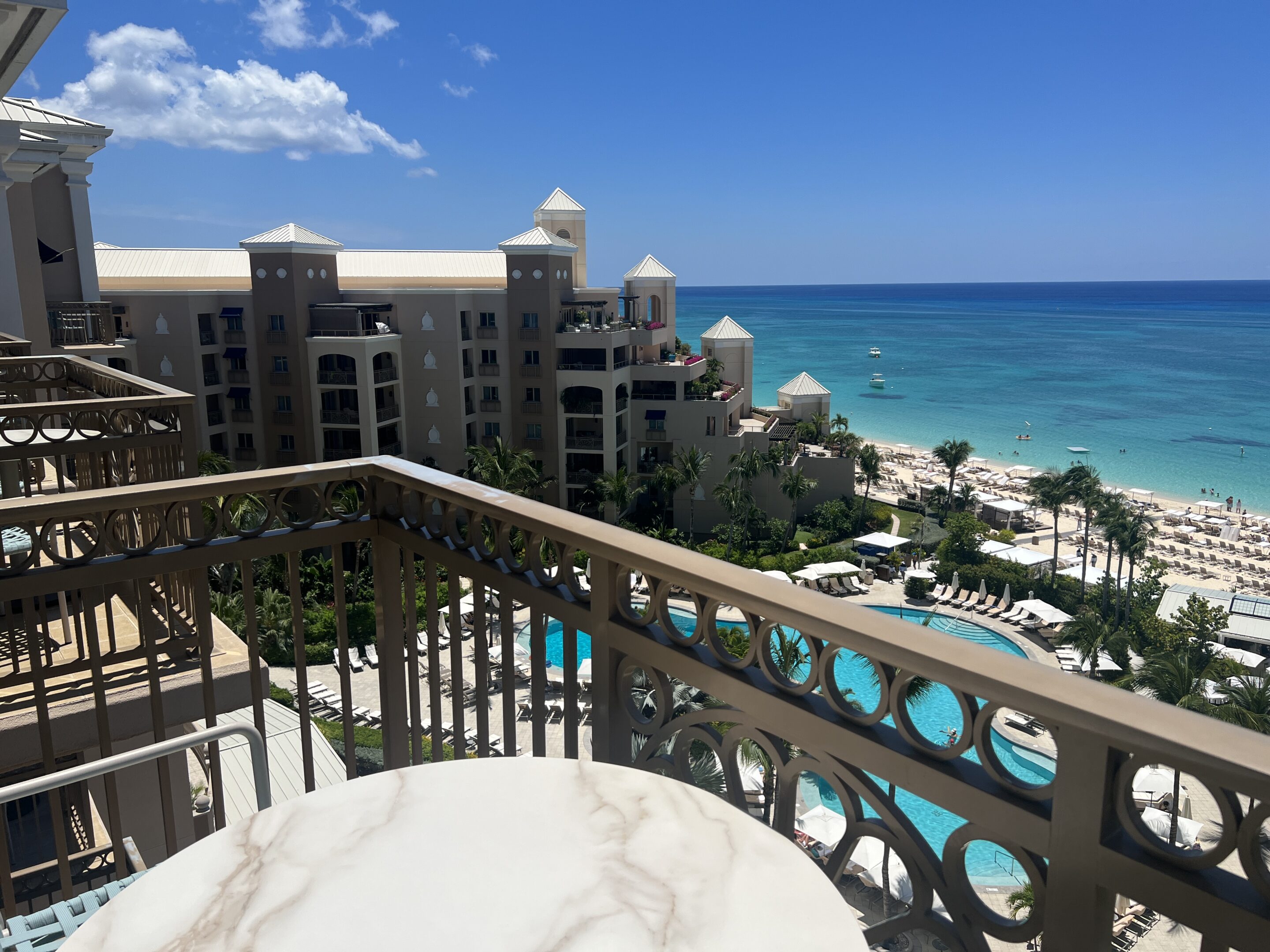 a balcony overlooking a beach and a hotel