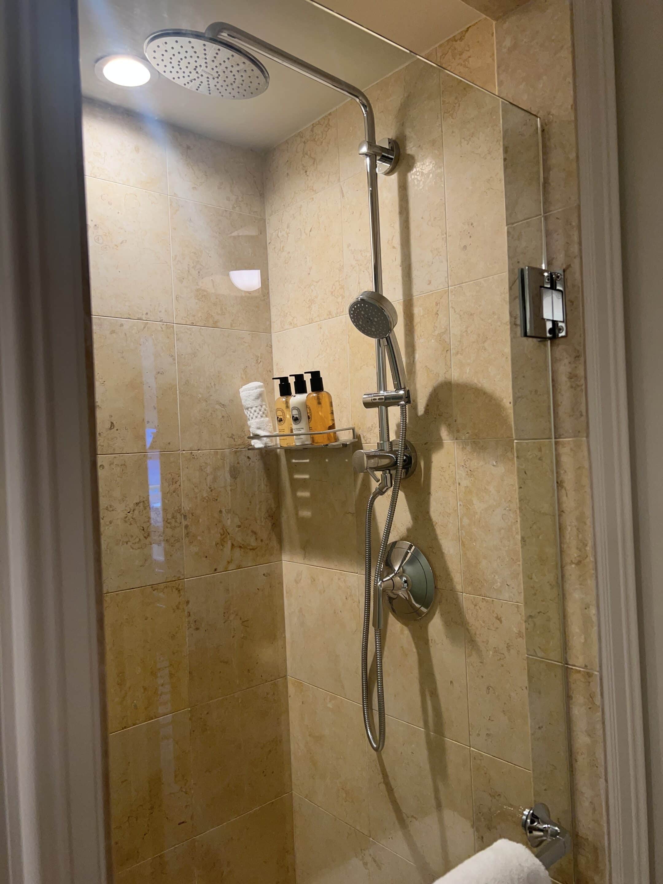 a shower with a shower head and a shower head