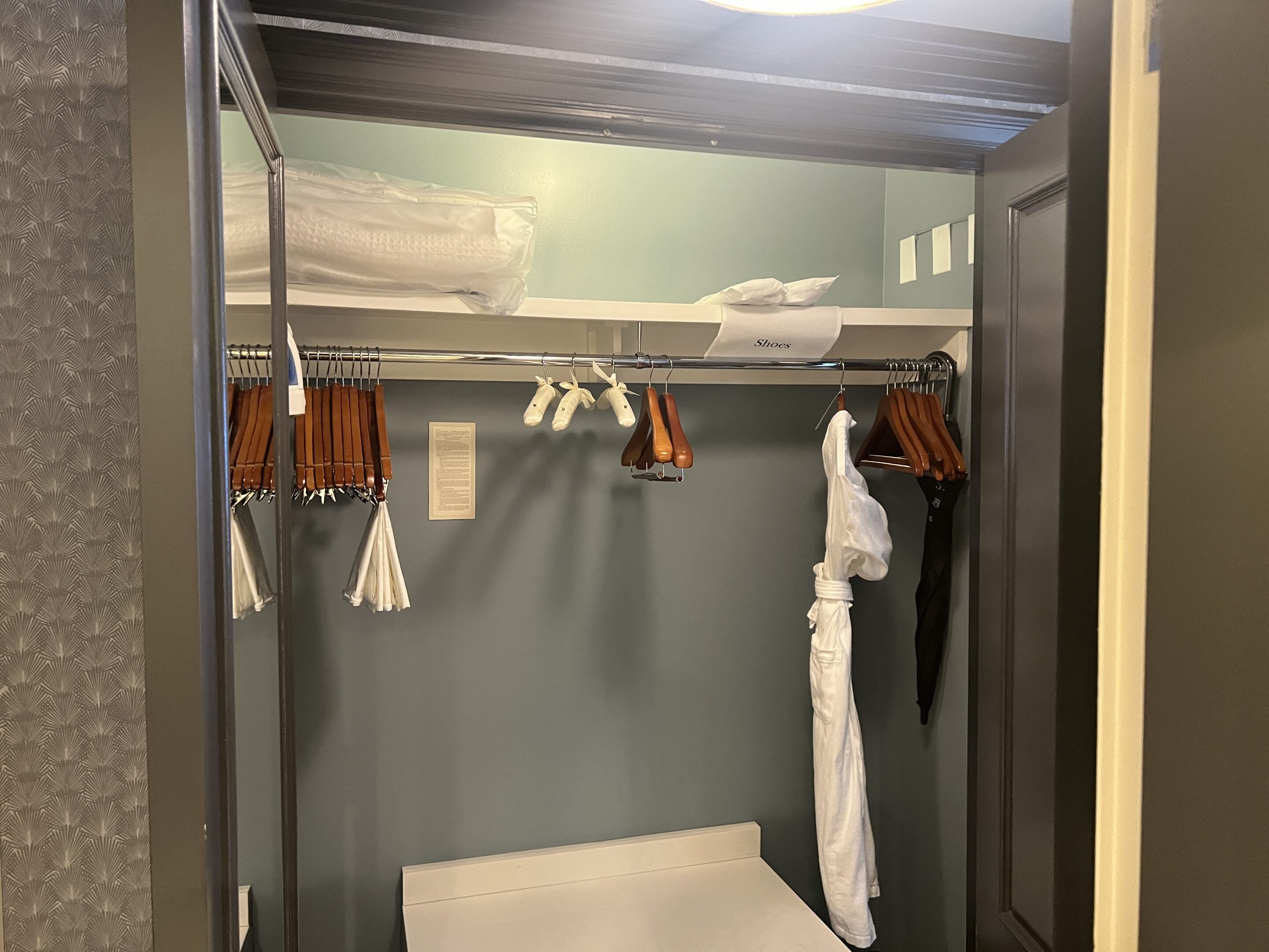 a closet with clothes on a rail