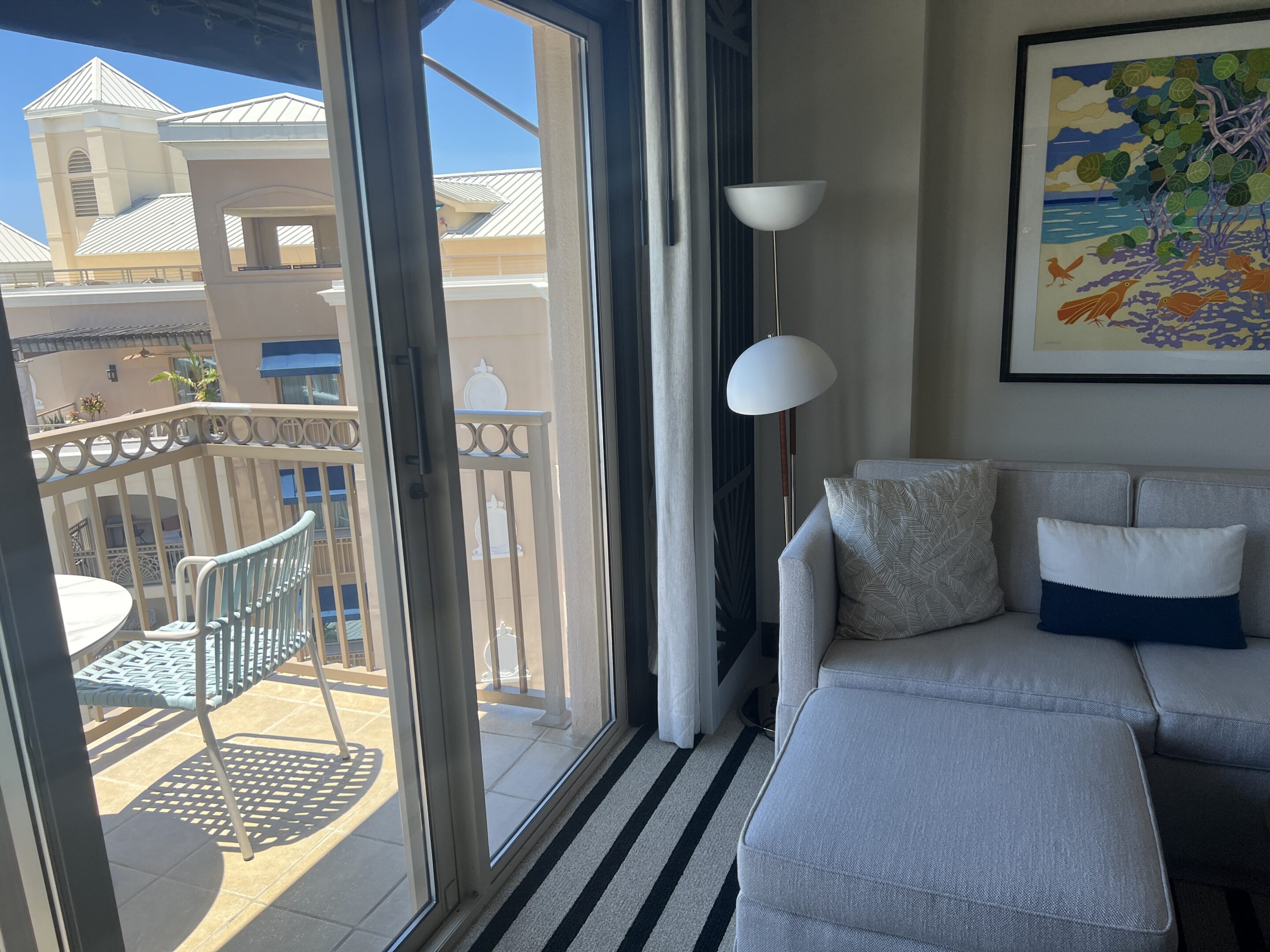 a living room with a couch and a glass door