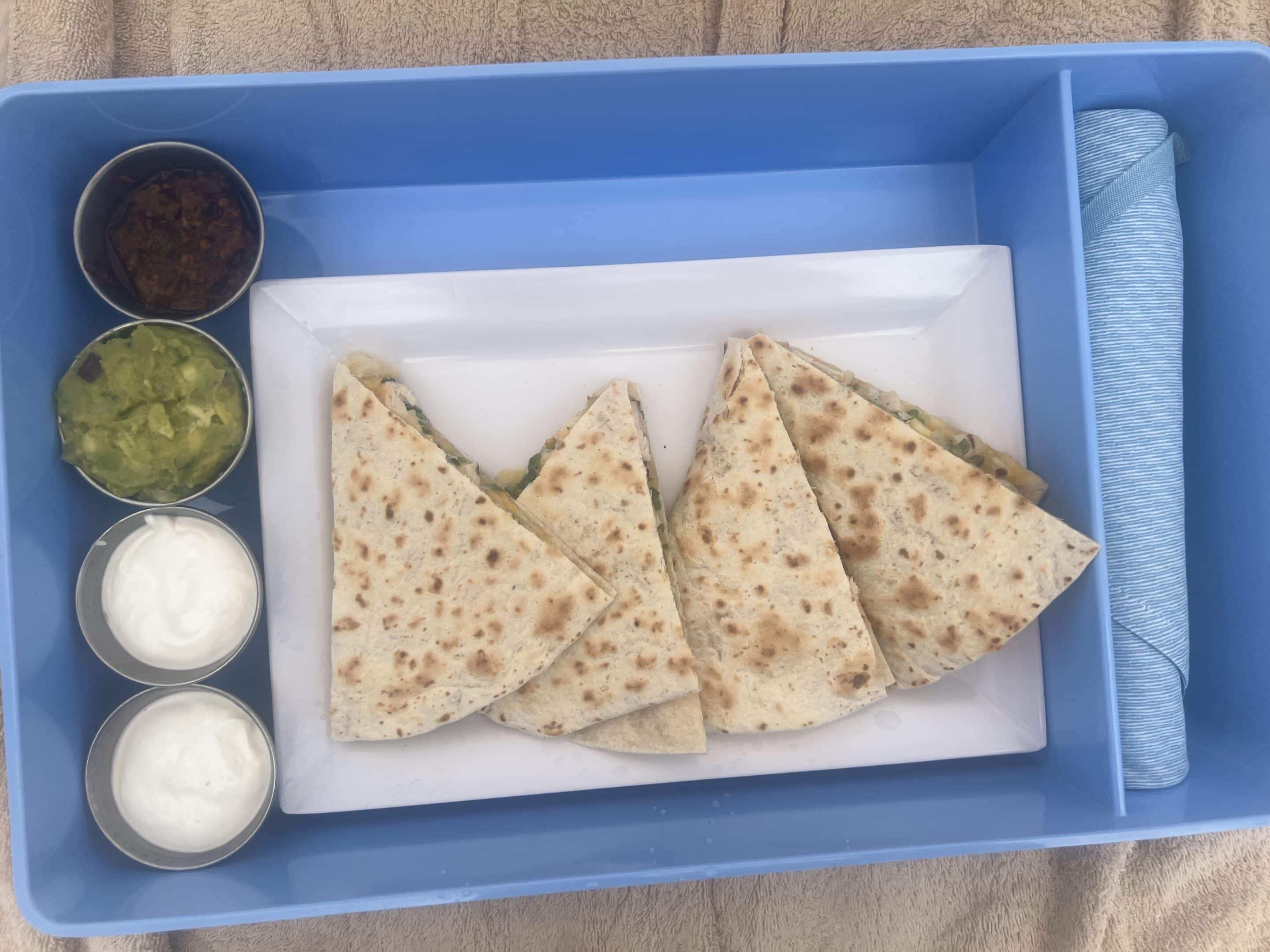 a plate of quesadillas and condiments