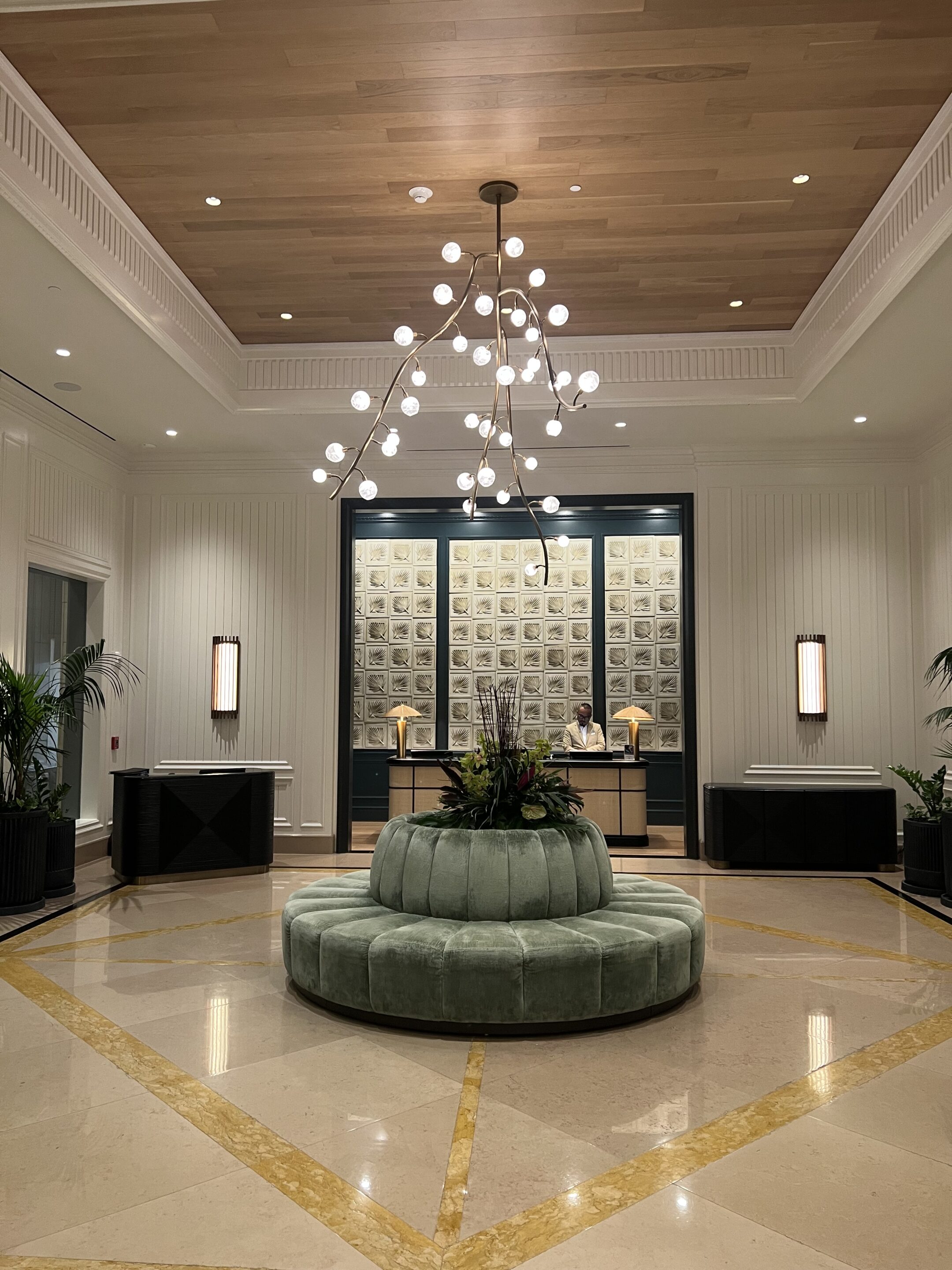 a chandelier in a room with a round bench