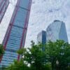 a group of tall buildings with trees in front of them