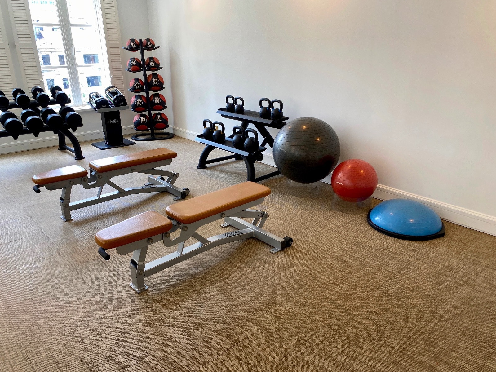 a room with exercise equipment and weights