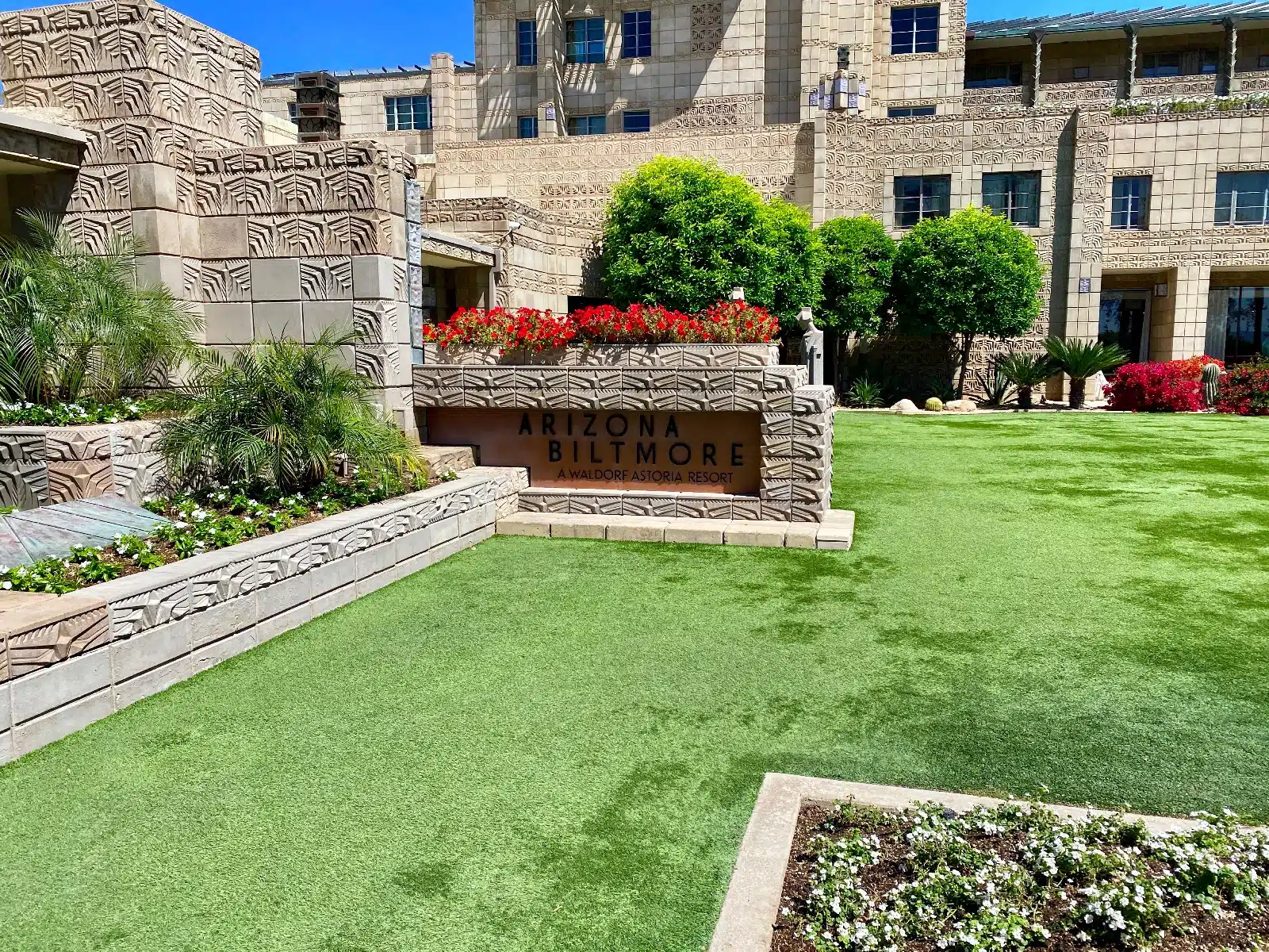 a building with a sign and a lawn