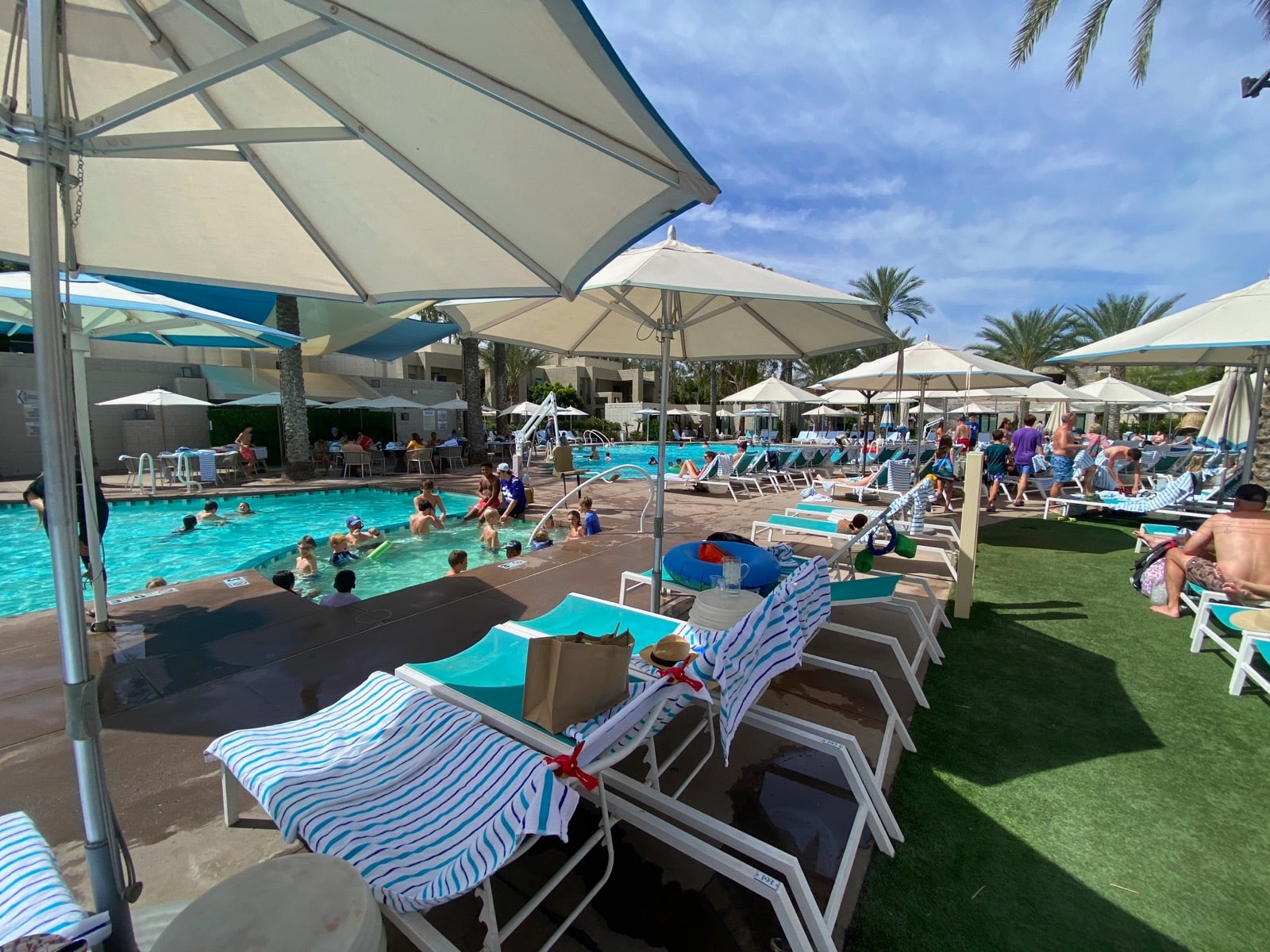 a pool with umbrellas and lounge chairs