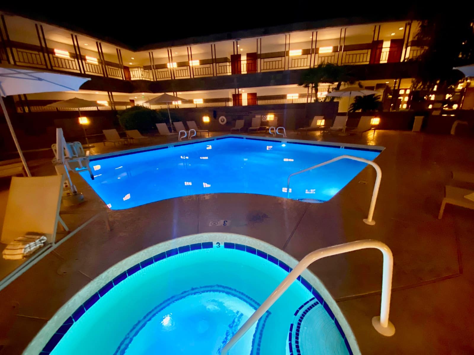 a pool with a blue light in the middle of a building