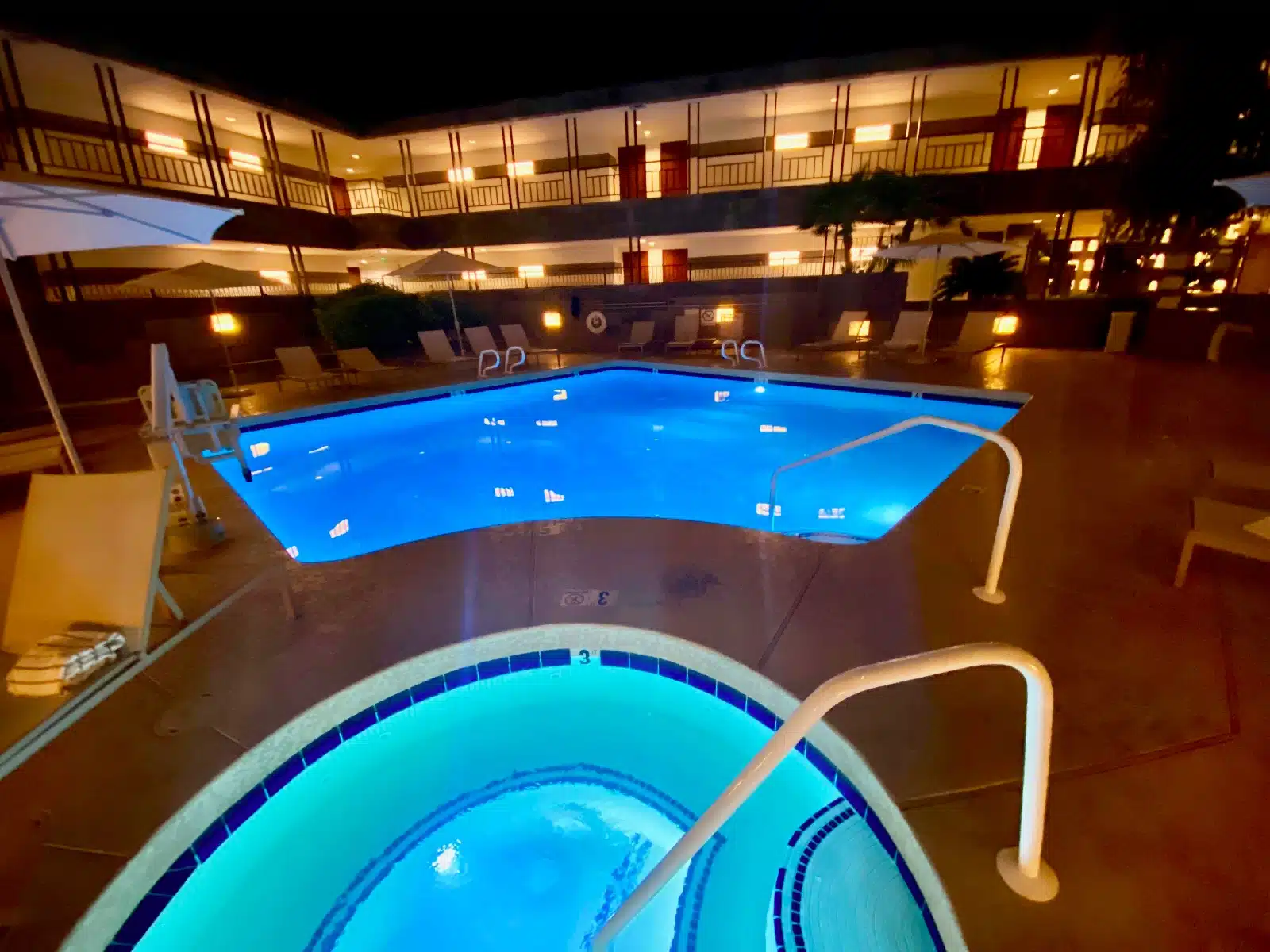 a pool with a blue light in the middle of a building