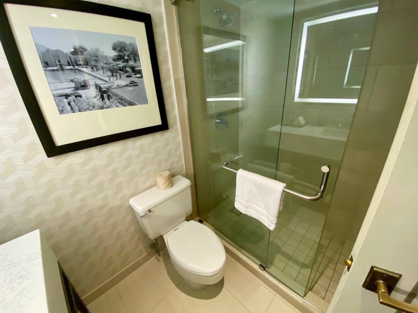 a bathroom with a glass shower door and a toilet