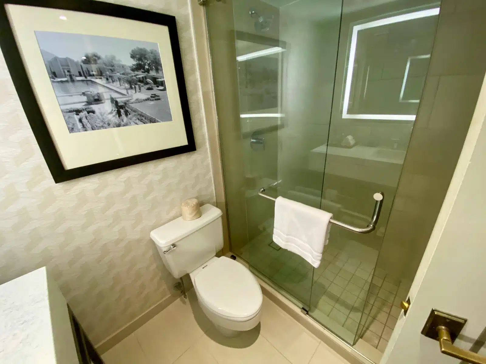a bathroom with a glass shower door and a toilet