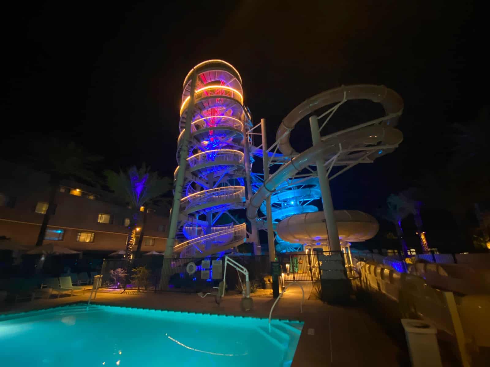 a water slide and pool at night