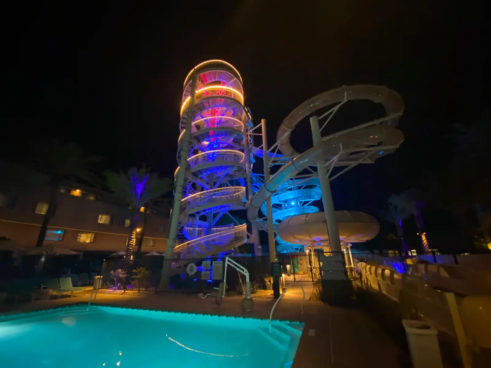 a water slide and pool at night