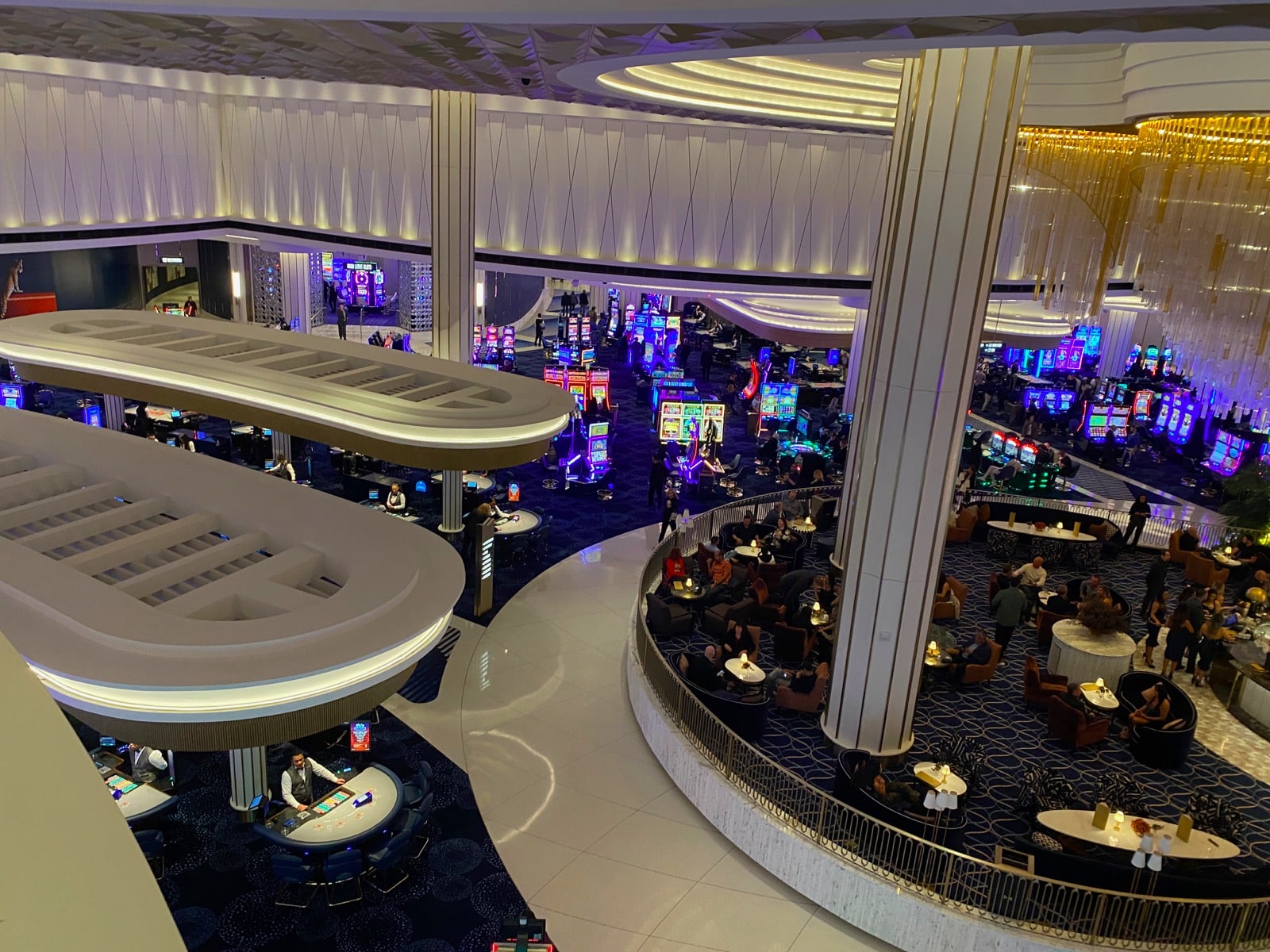 a large casino with people sitting at tables