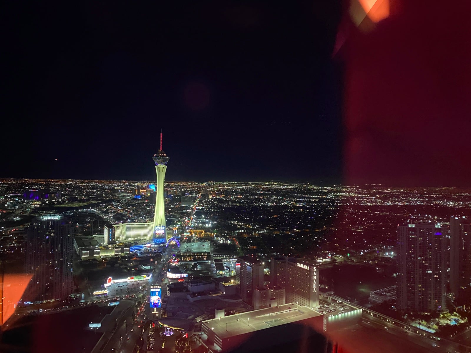 a city at night with a tall tower