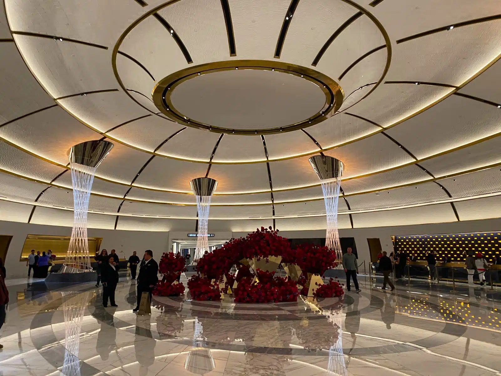 a large room with a large circular ceiling and a large flower arrangement