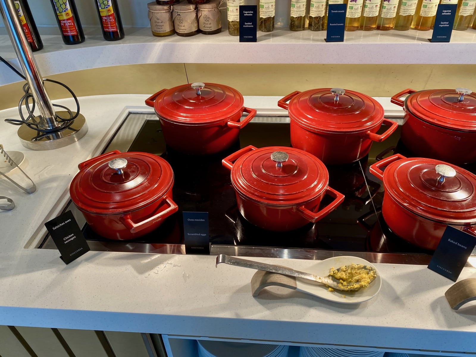 a group of red pots on a stove