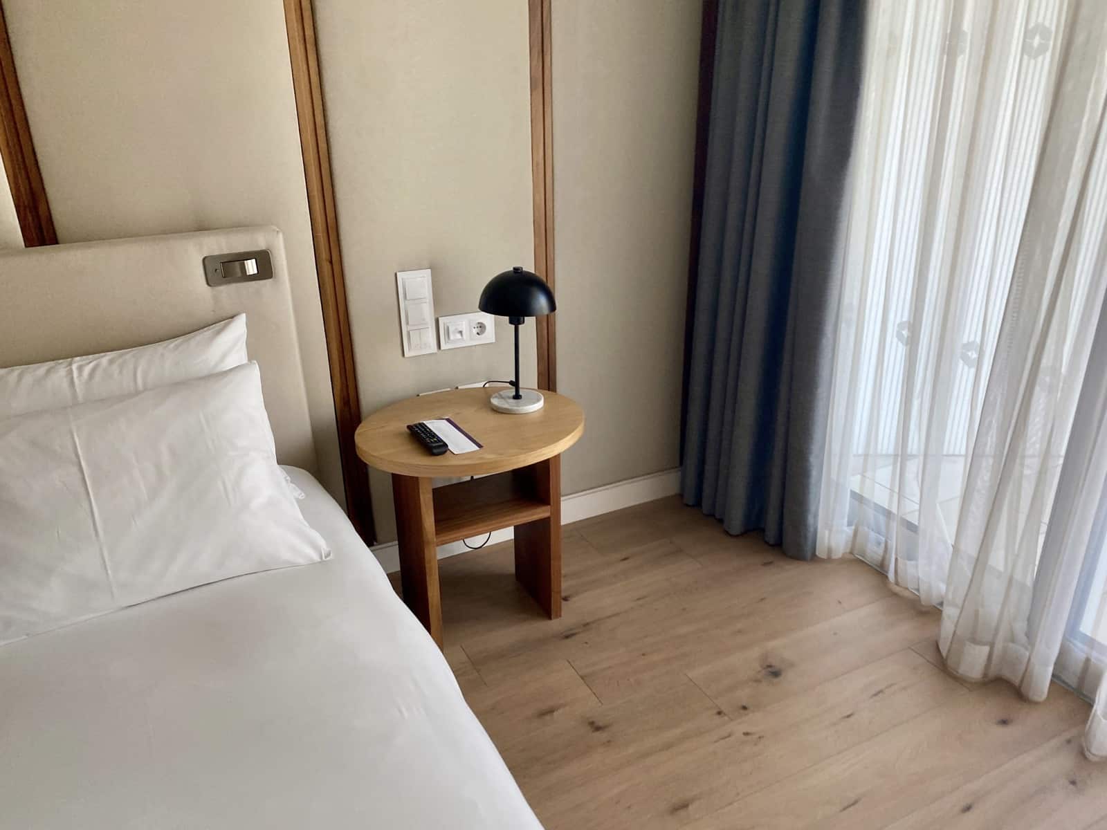 a bed with a lamp on a table