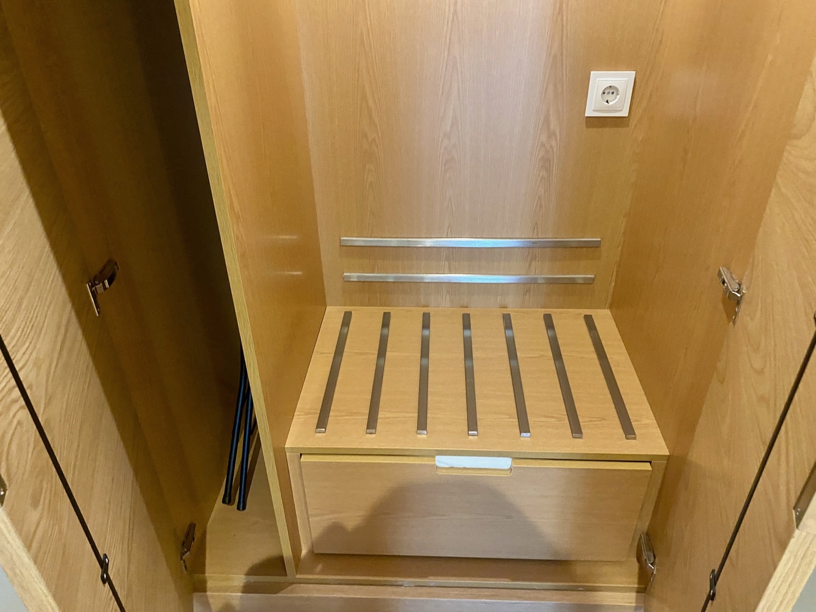 a wooden cabinet with a drawer